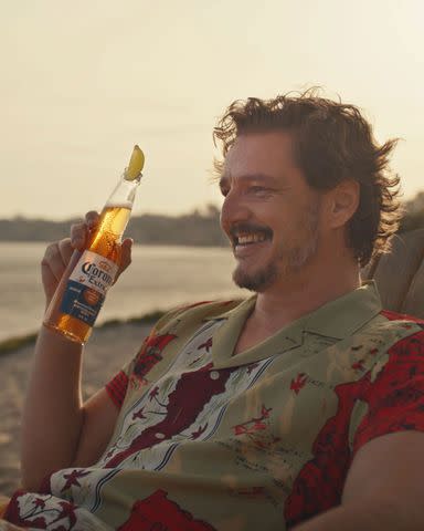 <p>Corona USA</p> Pedro Pascal enjoys a Corona.