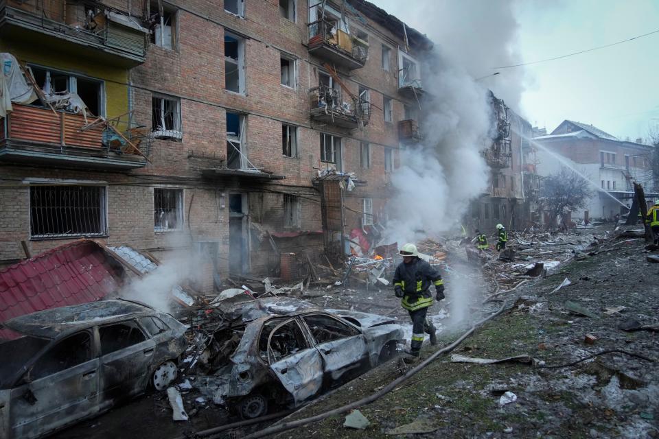 Ukrainian State Emergency Service firefighters work to extinguish a fire at the scene of a Russian shelling in the town of Vyshgorod outside the capital Kyiv, Ukraine, Wednesday, Nov. 23, 2022. The war in Ukraine has added weight to the word of the year, "permacrisis."