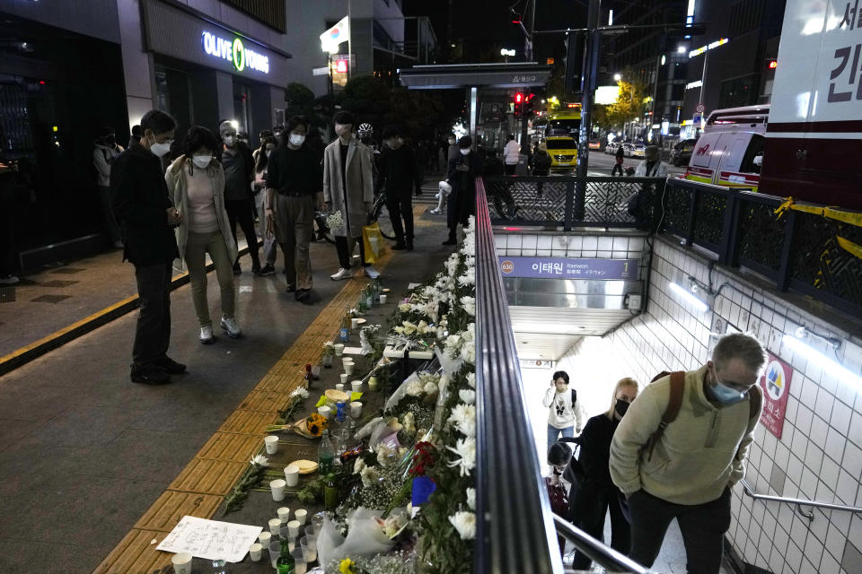 Flowers are displayed to pay tribute for victims near the scene of a deadly accident in Seoul, South Korea, Sunday, Oct. 30, 2022, following Saturday night's Halloween festivities. A mass of mostly young people celebrating Halloween festivities in Seoul became trapped and crushed as the crowd surged into a narrow alley, killing dozens of people and injuring dozens of others in South Korea's worst disaster in years. (AP Photo/Ahn Young-joon)