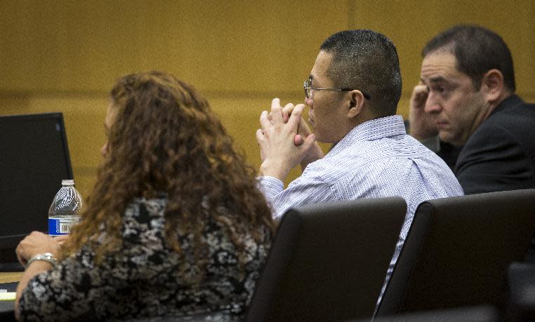 Johnathan Doody, one of the two young men charged in the 1991 Temple murders at a Buddhist temple in Waddell, sits impassively as jurors find him guilty on all counts, Thursday, Jan. 23, 2014, in Maricopa County Superior Court. Doody sits between his attorneys Maria Schaffer and David Rothschild. (AP Photo/The Arizona Republic,Charlie Leight ) MARICOPA COUNTY OUT; MAGS OUT; NO SALES