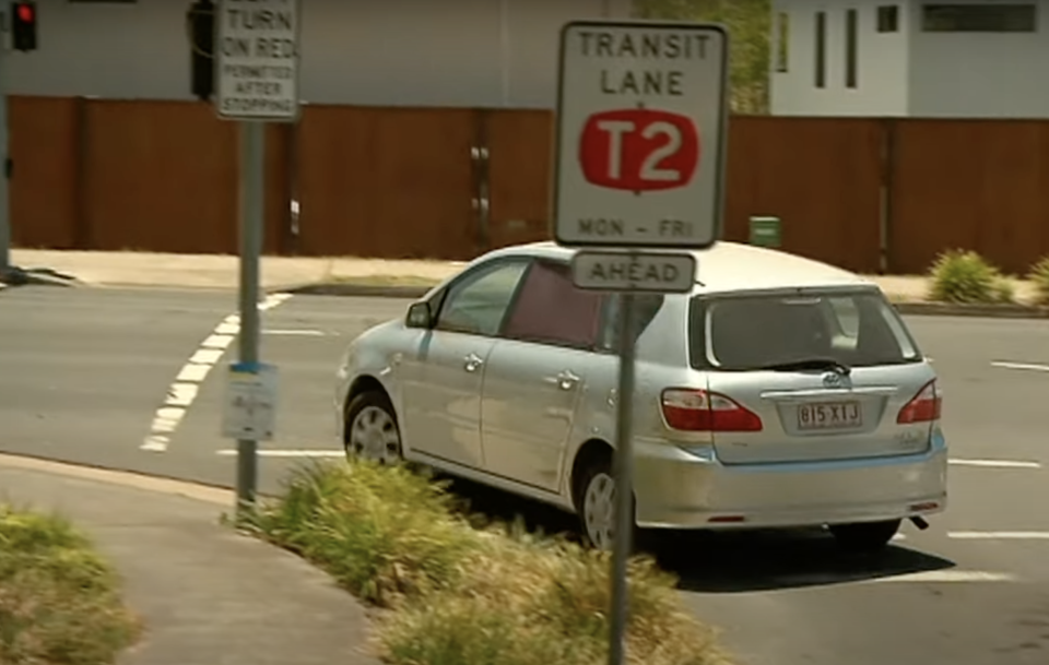 A car is pictured turning left at a red light in Brisbane.