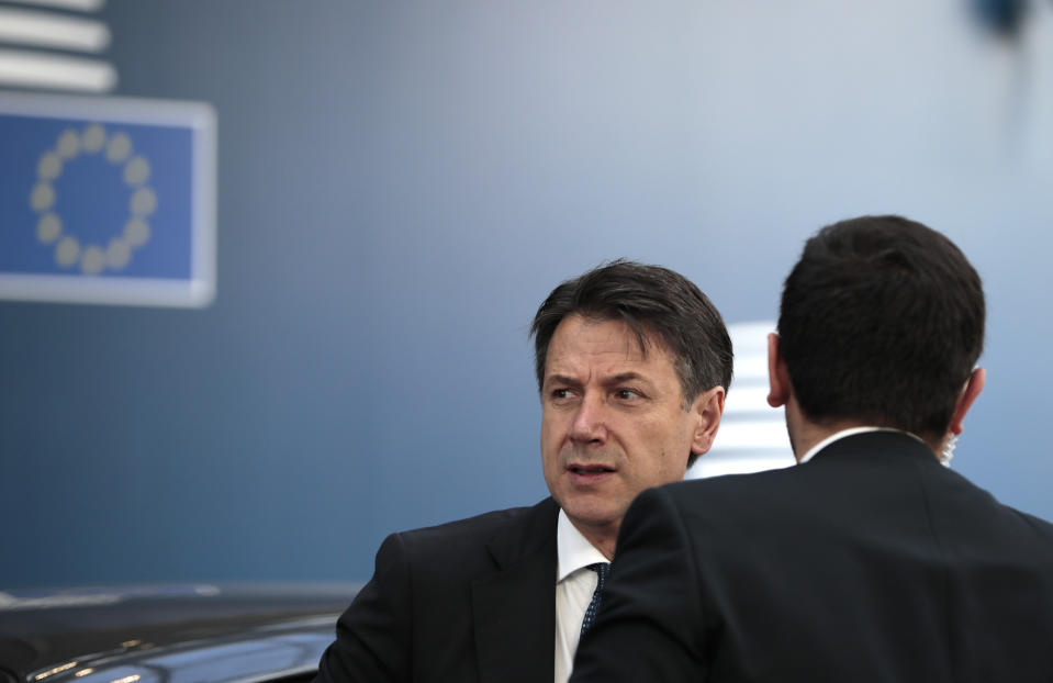 Italian Prime Minister Giuseppe Conte, left, arrives for an EU summit at the Europa building in Brussels, Friday, June 21, 2019. EU leaders conclude a two-day summit on Friday in which they will discuss the euro-area. (AP Photo/Virginia Mayo, Pool)