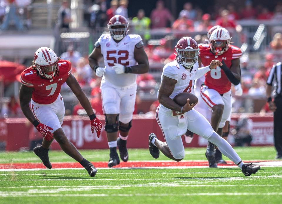 Alabama quarterback Jalen Milroe (4) runs the ball through a defense during the game against Wisconsin at Camp Randall Stadium in Madison, Wis. on Saturday, September 14, 2024.