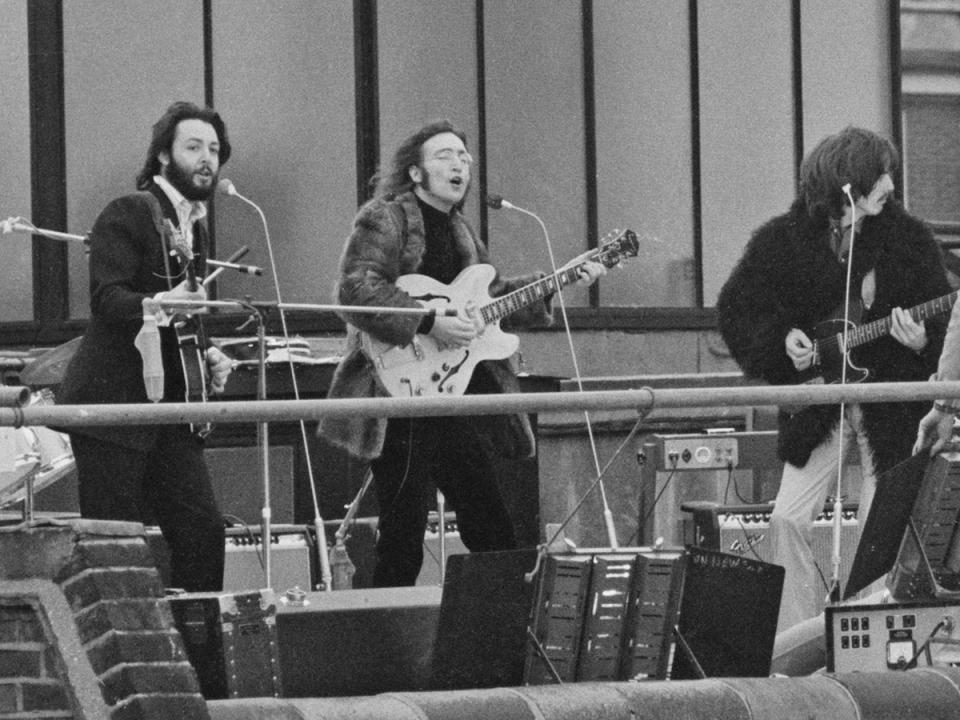 The band performing their last live public concert on the rooftop of the Apple Corps building (Getty)