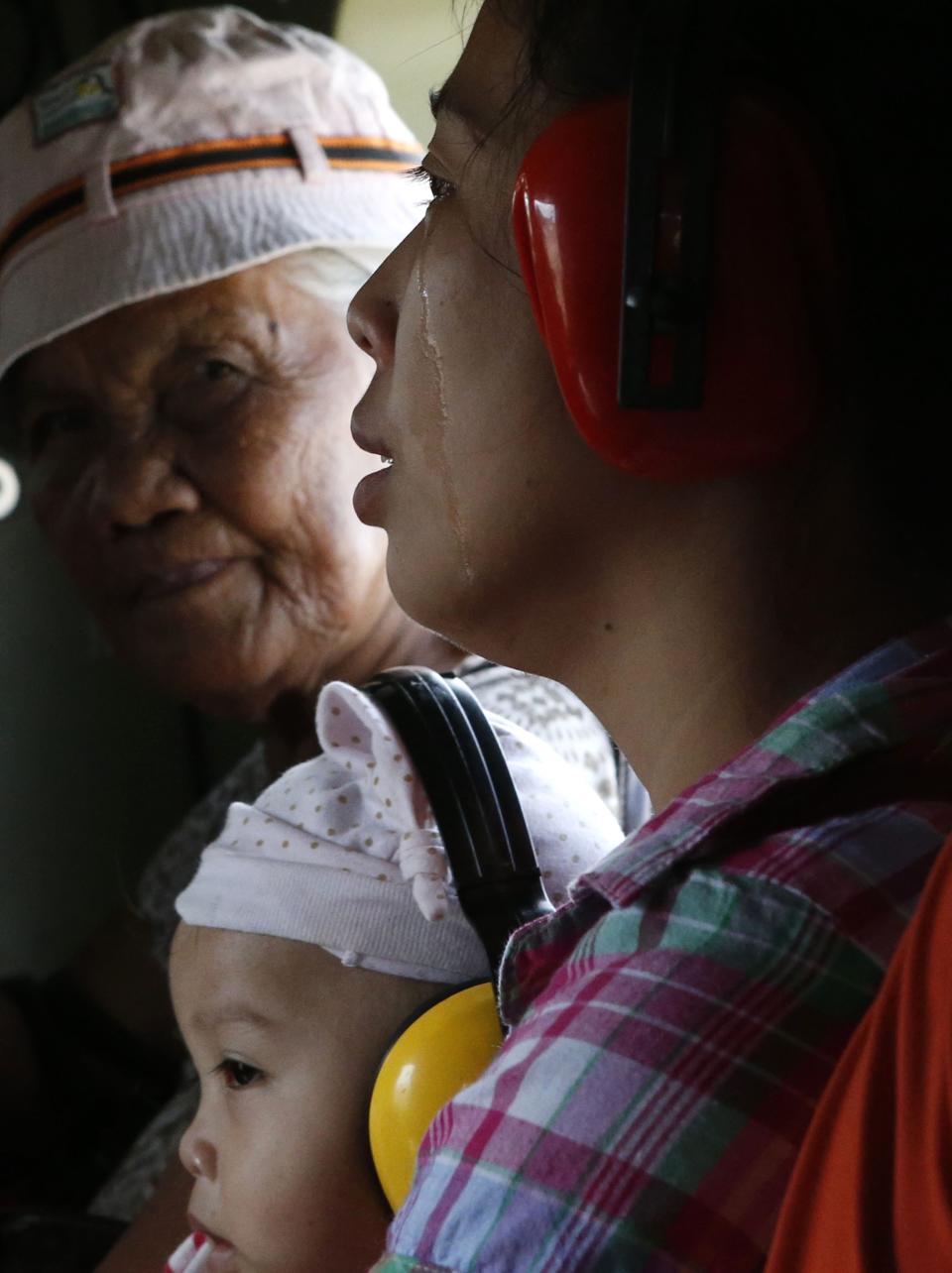 A typhoon survivor cries while she and her sick baby are evacuated by a military helicopter from Guiwan, Samar, that was among those areas battered by super Typhoon Haiyan in central Philippines