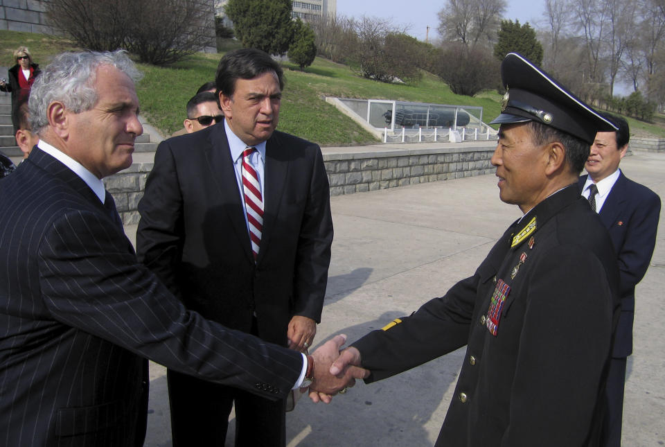FILE - North Korean Col. Pak In Ho, right, shakes hands with Anthony Principi, former Secretary of Veterans Affairs, as Gov. Bill Richardson of New Mexico looks on in Pyongyang, North Korea, Monday, April 9, 2007, prior to a visit aboard the USS Pueblo. Richardson, a two-term Democratic governor of New Mexico who later was the U.S. ambassador to the United Nations and dedicated his post-political career to working to free Americans detained overseas, has died, Saturday, Sept. 2, 2023. (AP Photo/Foster Klug, File)