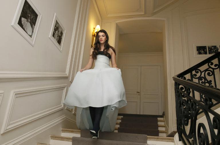 Kyra Kennedy, great niece of late President John F. Kennedy and daughter of Robert Kennedy Jr, walks down the stairs as she tries her new dress at Dior in Paris, on November 27, 2013, ahead of the Debutante Ball