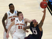 Connecticut's Shabazz Napier, right, is hit on the face by Iowa State's Matt Thomas while shooting during the second half in a regional semifinal of the NCAA men's college basketball tournament Friday, March 28, 2014, in New York. Iowa State's DeAndre Kane is at rear. (AP Photo/Julio Cortez)