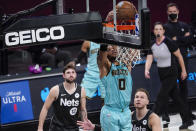 Charlotte Hornets forward Miles Bridges (0) dunks during the second half of the team's NBA basketball game against the Brooklyn Nets, Friday, April 16, 2021, in New York. (AP Photo/Mary Altaffer)