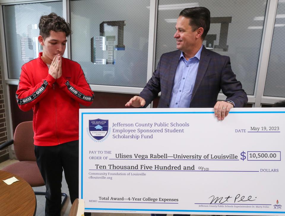 Ulises Vega Rabel, a student at Doss High School, receives a $10,500 scholarship check from superintendent Marty Pollio.  The money comes from the Jefferson County Public Schools Employee Sponsored Student Scholarship Fund.  $70,000 was awarded on Friday, May 19, 2023, to students at six JCPS high schools.