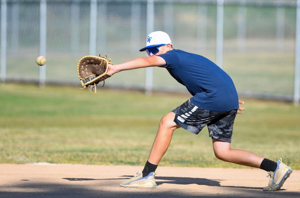 Max Vortherms (#99) makes a catch during Little League practice on Monday, August 1, 2022, at Cherry Rock Park in Sioux Falls.