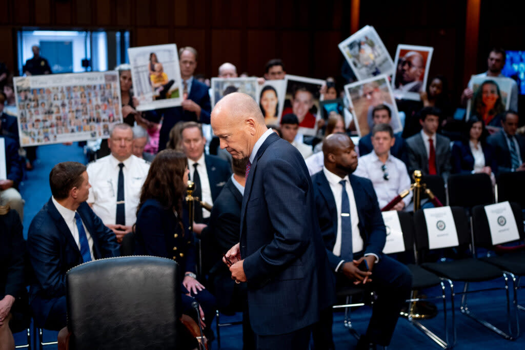 Boeing CEO Dave Calhoun returns to his seat