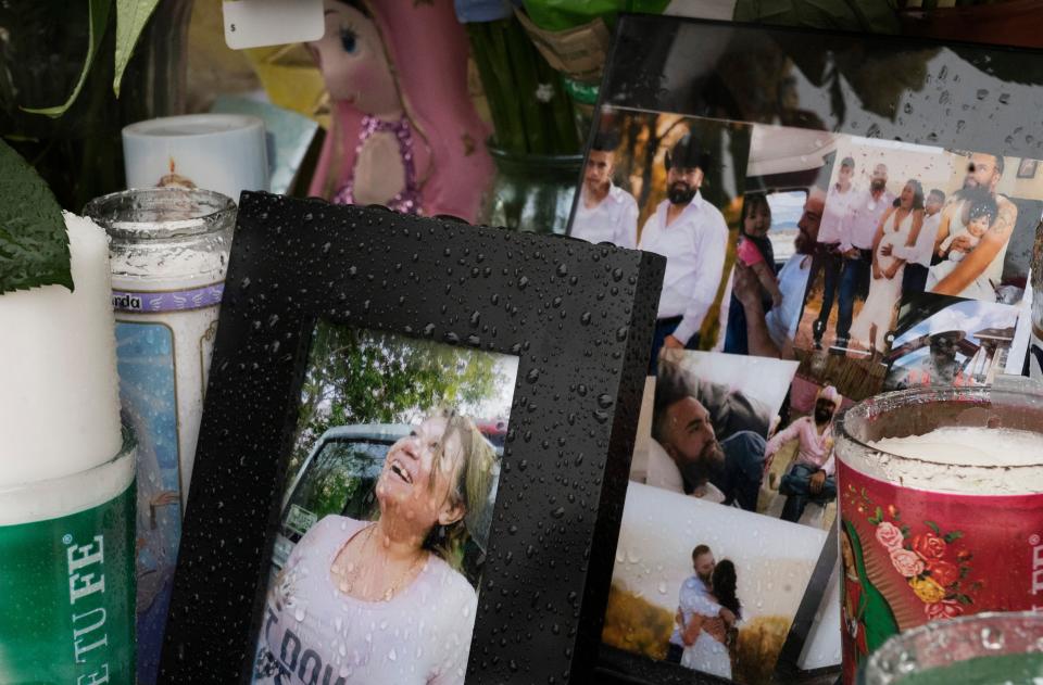 A photo of one of the victims, Joana Cruz,  in the foreground, is seen at a makeshift memorialAP