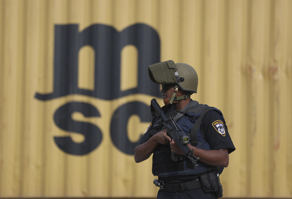 Israeli policemen stand at then entrance of Barkan industrial zone in the West Bank Sunday, Oct. 7, 2018. A Palestinian attacker opened fire at a joint Israeli-Palestinian industrial zone in the West Bank Sunday, killing two Israelis and seriously wounding a third, the military said. (AP Photo/Oded Balilty)