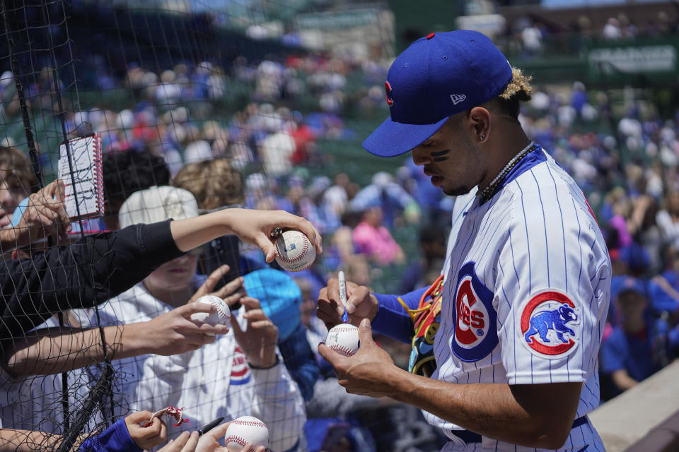 Chicago Cubs' Christopher Morel signs autographs for fans before a baseball game against the Cincinnati Reds Friday, May 26, 2023, in Chicago. (AP Photo/Erin Hooley)