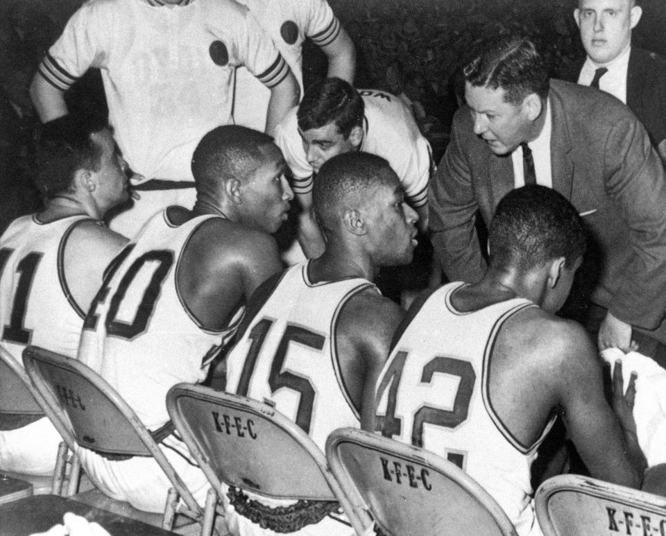 Loyola coach George Ireland talks with his team during the 1963 NCAA title game vs. Cincinnati. Chuck Wood, the team's sixth man from Racine, is to Ireland's right. Seated (left to right) are starters John Egan, Vic Rouse, Jerry Harkness and Ron Miller.