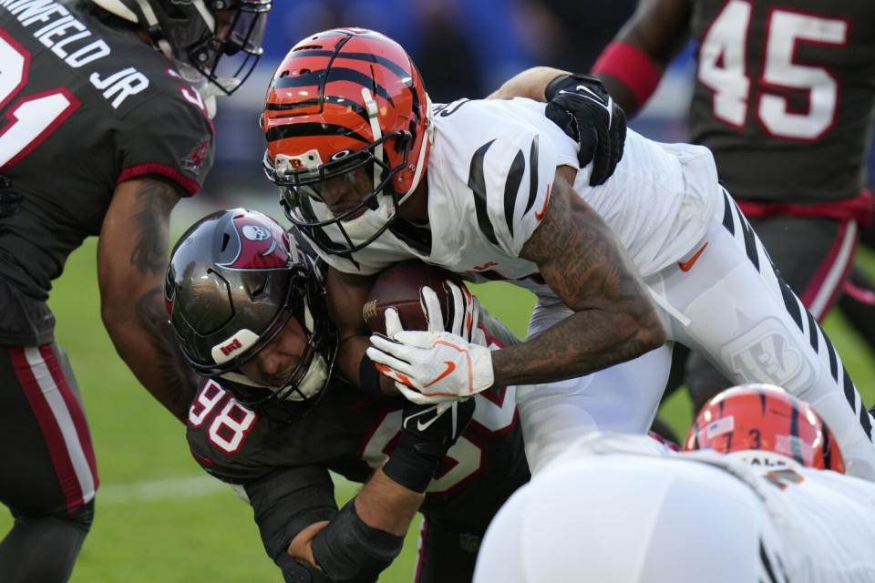 Cincinnati Bengals wide receiver Ja'Marr Chase is stopped by Tampa Bay Buccaneers linebacker Anthony Nelson.