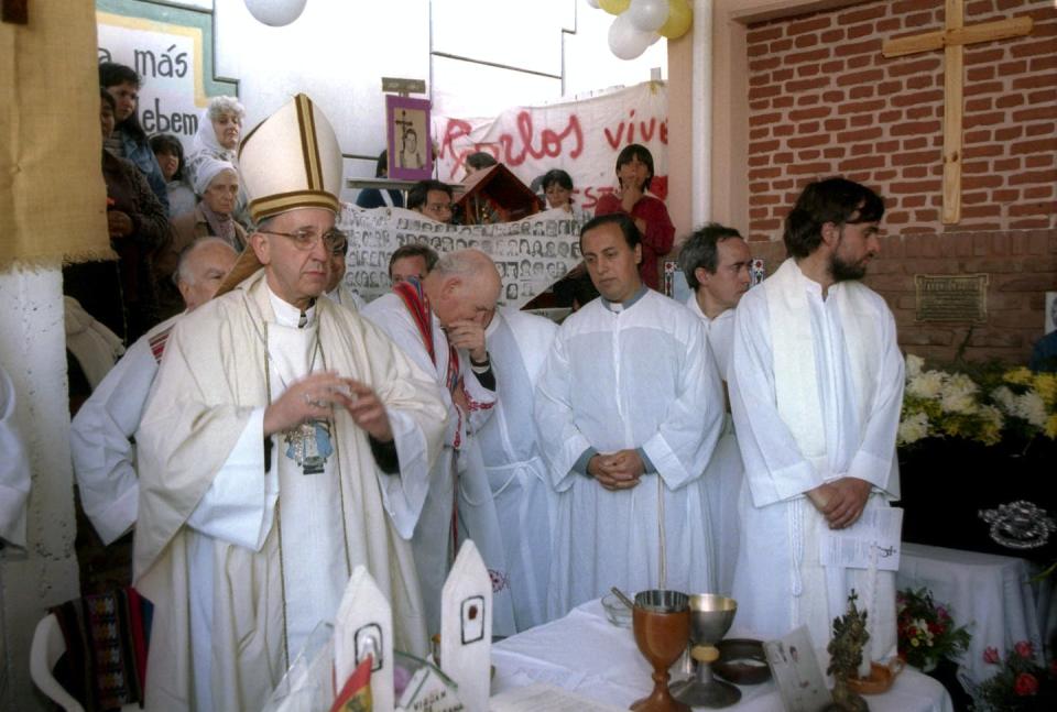 In this 2000 photo, Pope Francis, then the archbishop of Argentina, gives a mass in honor of slain priest Carlos Mugica, whose ministry was influenced by liberation theology. <a href="https://newsroom.ap.org/detail/ArgentinaSlumPope/9c5679aec7ef443493c73ce3757c7546/photo?Query=%22liberation%20theology%22&mediaType=photo&sortBy=arrivaldatetime:desc&dateRange=Anytime&totalCount=33&currentItemNo=23" rel="nofollow noopener" target="_blank" data-ylk="slk:AP Photo;elm:context_link;itc:0;sec:content-canvas" class="link ">AP Photo</a>