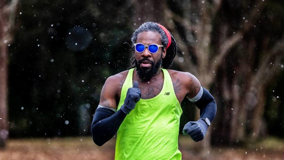 Jamil Rashad braves freezing temperatures as snow begins on his afternoon run along North King Charles Blvd. in Raleigh Friday, Jan. 21, 2022.