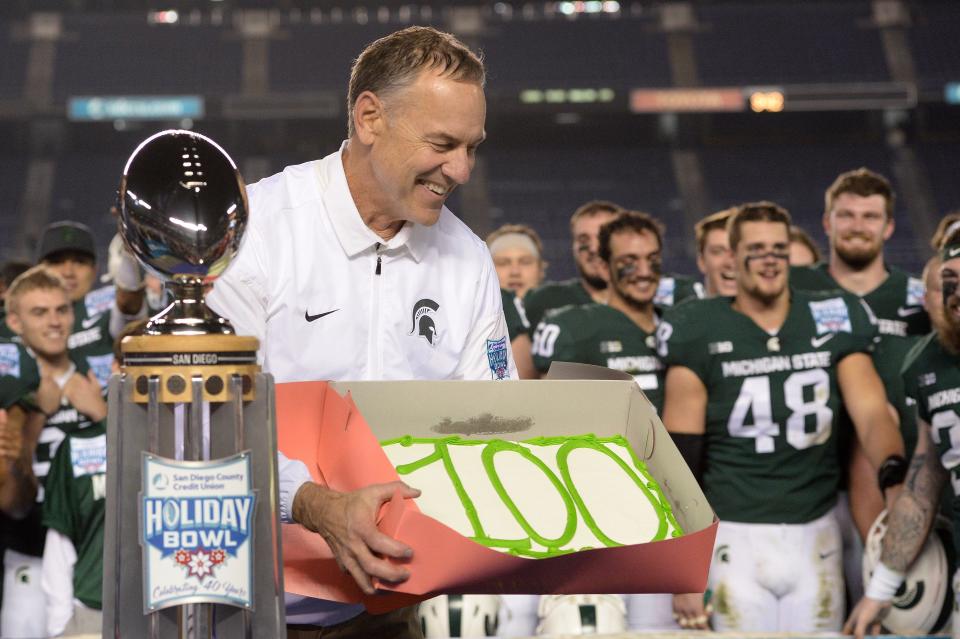 Michigan State Spartans head coach Mark Dantonio is gifted with a cake to celebrate his 100th victory after defeating the Washington State Cougars in the 2017 Holiday Bowl at SDCCU Stadium.