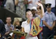 Petra Kvitova of Czech Republic waves while holding the winner's trophy, the Venus Rosewater Dish, after defeating Eugenie Bouchard of Canada in their women's singles final tennis match at the Wimbledon Tennis Championships in London July 5, 2014. REUTERS/Suzanne Plunkett