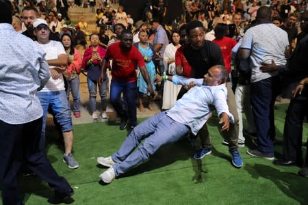 A man falls backward during a religious retreat lead by T.B. Joshua, a Nigerian evangelical preacher on Mount Precipice, Nazareth