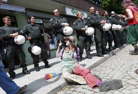 Police look at an anti-G7 protestor during a demonstration in Garmisch-Partenkirchen, southern Germany, June 6, 2015. The Group of Seven (G7) two-day summit, being held at Elmau palace near Garmisch-Partenkirchen in Bavaria, begins on Sunday. REUTERS/Michaela Rehle