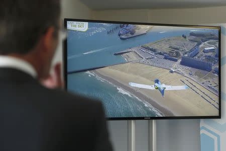 Airbus Group Senior Vice President of Strategy and Corporate Development, Ken McKenzie, watches on a screen at Lydd Airport as the Airbus Group E-Fan electric aircraft comes in to land in Calais after flying across the channel from Lydd Airport in southeast England, Britain July 10, 2015. REUTERS/Luke MacGregor