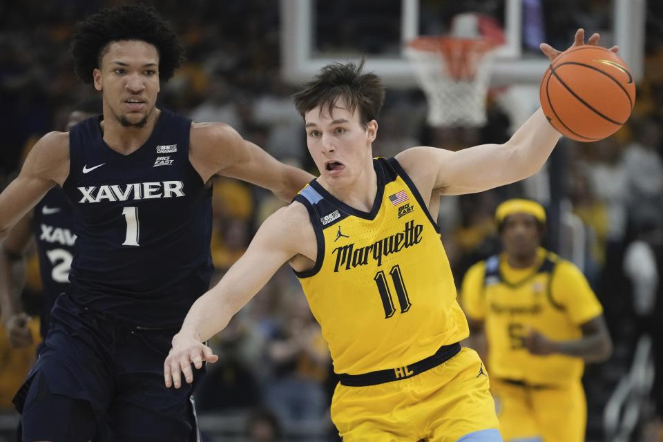 Marquette's Tyler Kolek gets ask Xavier's Desmond Claude during the first half of an NCAA college basketball game Sunday, Feb. 25, 2024, in Milwaukee. (AP Photo/Morry Gash)
