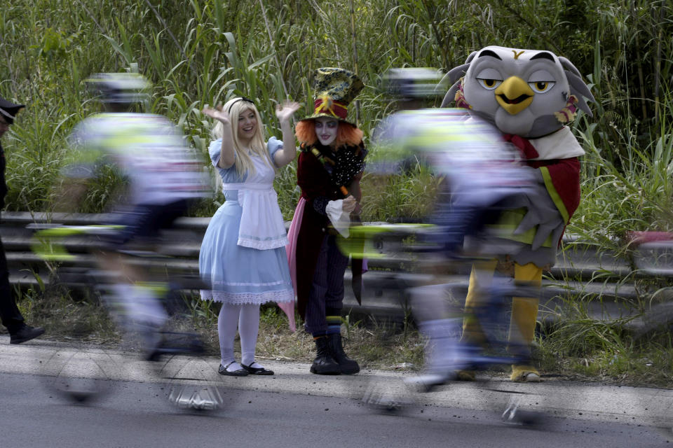 Fans in costumes wave as the cyclists pedal during the 9th stage of the of the Giro d'Italia cycling race, from Avezzano to Naples, Italy, Sunday, May 12, 2024. (Fabio Ferrari/LaPresse via AP)