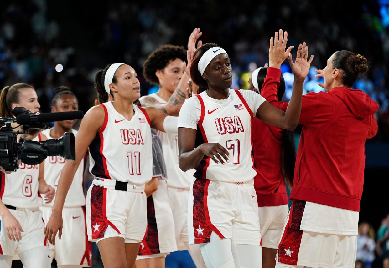 The U.S. women's basketball team celebrates after defeating Australia in Friday's Olympic semifinal.