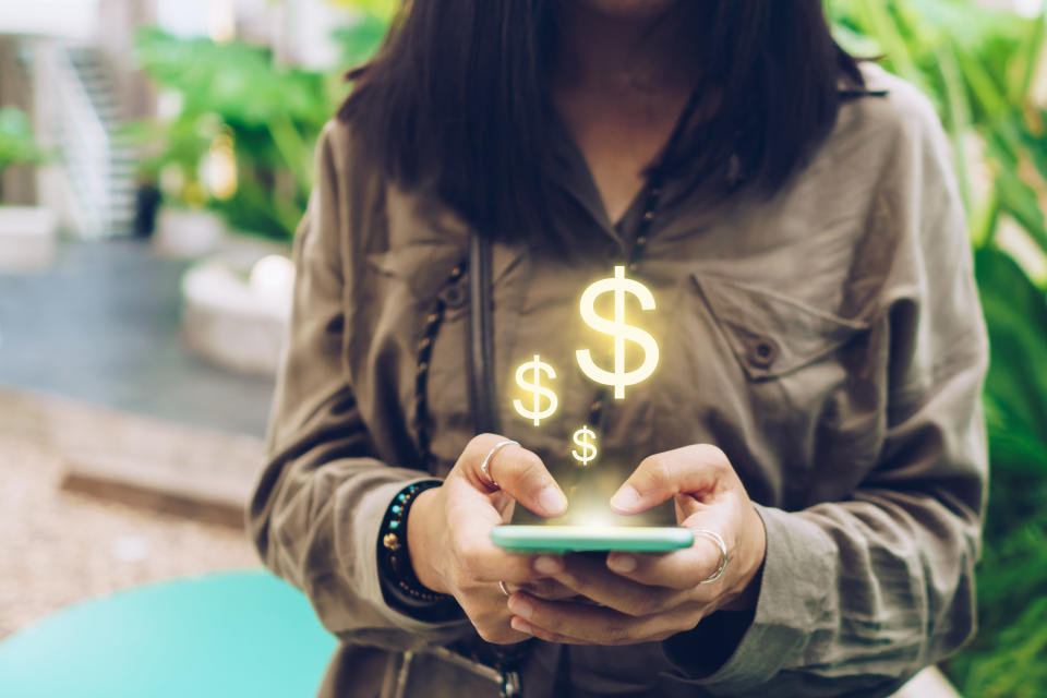 A woman paying her bills on a phone