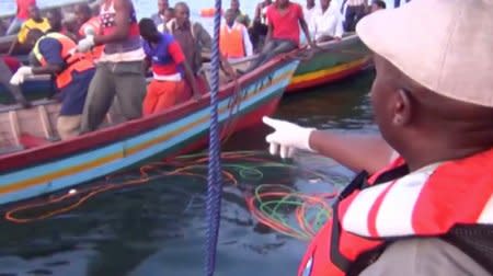 Rescue workers are seen at the scene where a ferry overturned in Lake Victoria, Tanzania September 21, 2018, in this still image taken from video. Reuters TV/via REUTERS - RC16AD388250