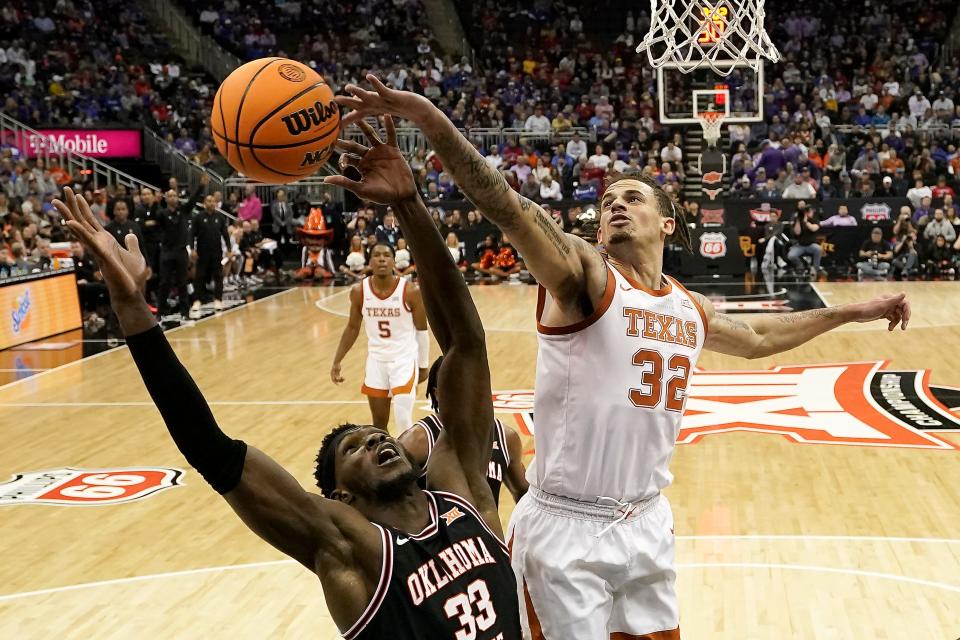 Oklahoma State forward Moussa Cisse (33) and Texas forward Christian Bishop (32) battle for a rebound during the second half of an NCAA college basketball game in the second round of the Big 12 Conference tournament Thursday, March 9, 2023, in Kansas City, Mo. (AP Photo/Charlie Riedel)