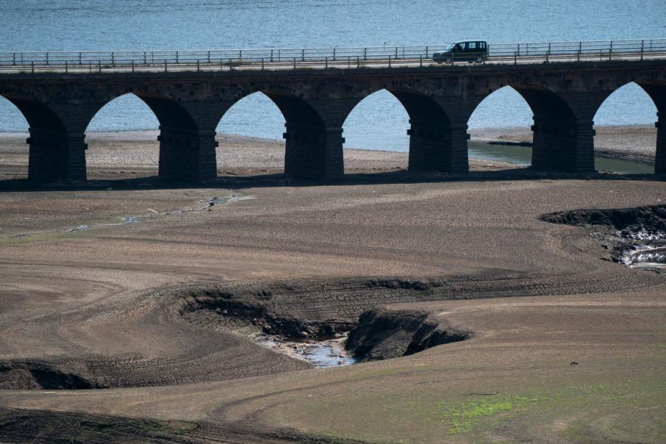 Traffic crosses a bridge at Woodhead Reservoir in West Yorkshire (AP)