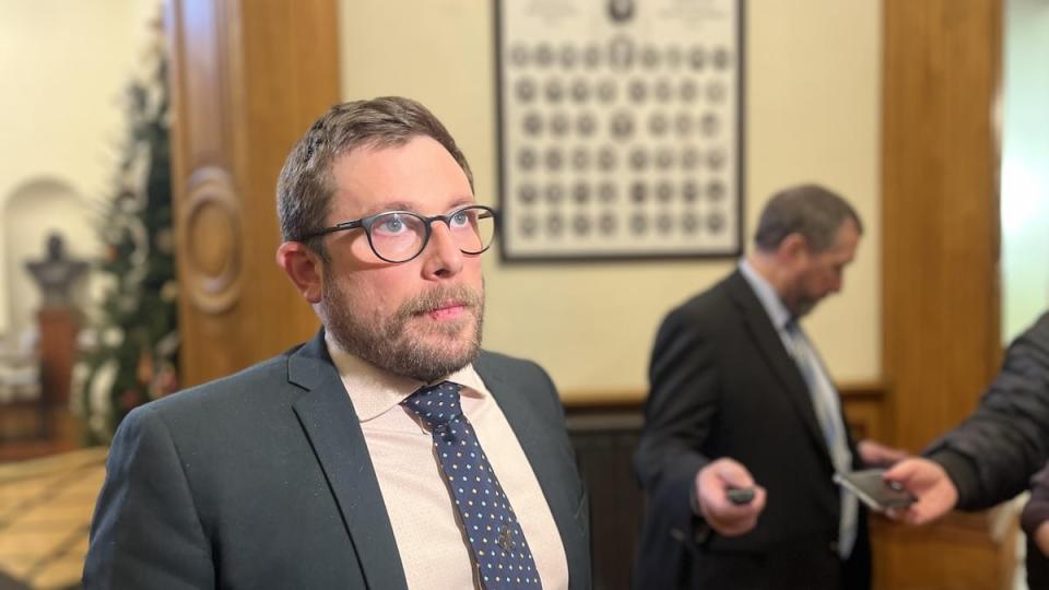 Green Party MLA Kevin Arseneau speaking to reporters in the New Brunswick legislature.