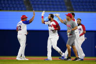 Dominican Republic's Jose Bautista, center, celebrate with teammates after hitting the game winning RBI single during the ninth inning of a baseball game against Israel at the 2020 Summer Olympics, Tuesday, Aug. 3, 2021, in Yokohama, Japan. The Dominican Republic won 7-6. (AP Photo/Matt Slocum)