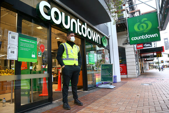A security guard stands outside the Willis Street Countdown Supermarket during the first day of a nationwide lockdown in Wellington, New Zealand. 