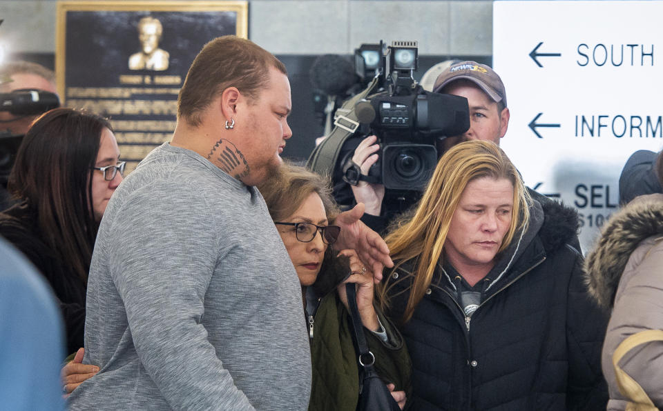 FILE - In this Feb. 21, 2019, file photo, several members of James Alan Neal's family leave El Paso County's Terry R. Harris Judicial Complex in Colorado Springs, Colo. Neal, 72, was arrested Tuesday, Feb. 19, 2019, in Colorado Springs, Colo., and charged with murder with special circumstances in the death of Linda O'Keefe, who was found strangled in 1973, a case that has long shaken the seaside community of Newport Beach, Calif., Orange County District Attorney Todd Spitzer said. James Neal of Monument, Colo. also pleaded not guilty in an Orange County courtroom Friday, March 29, 2019, to lewd and lascivious acts on two girls under the age of 14. Those alleged crimes happened between 1995 and 2004 in Riverside County east of Los Angeles. (Dougal Brownlie/The Gazette via AP, File)