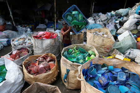 A worker sorts used plastic at a plastic recycling center in Jakarta, Indonesia, November 20, 2018. REUTERS/Willy Kurniawan/Files