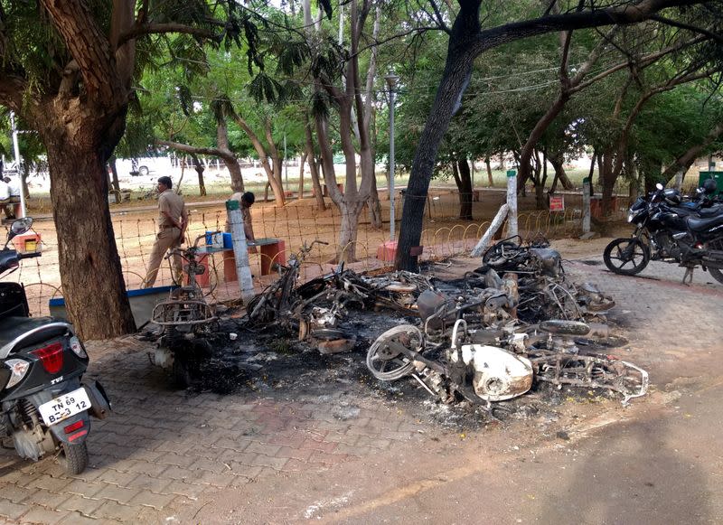 Charred vehicles are pictured near a government office, after at least 13 people were killed when police fired on protesters seeking closure of plant on environmental grounds in town of Thoothukudi