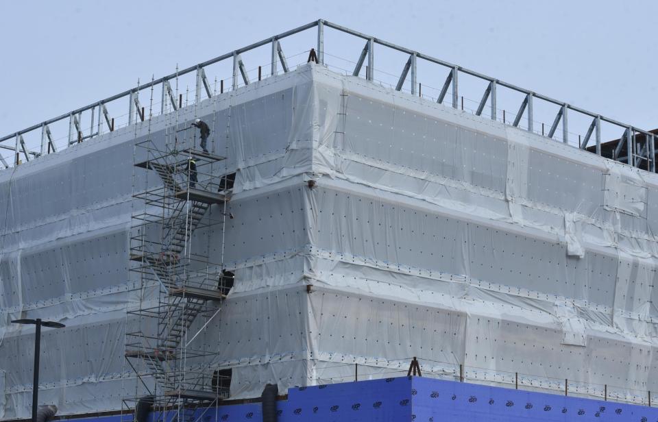 Workers build scaffolding Jan. 9. on the side of the new Peter and Pamela Barbey Patient Tower at Cape Cod Hospital in Hyannis.