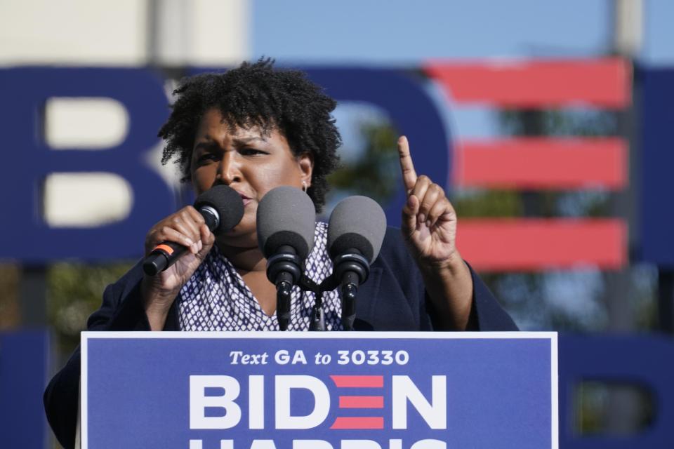 Stacey Abrams speaks to Biden supporters as they wait for former President Barack Obama to arrive and speak at a rally on Nov. 2 in Atlanta.