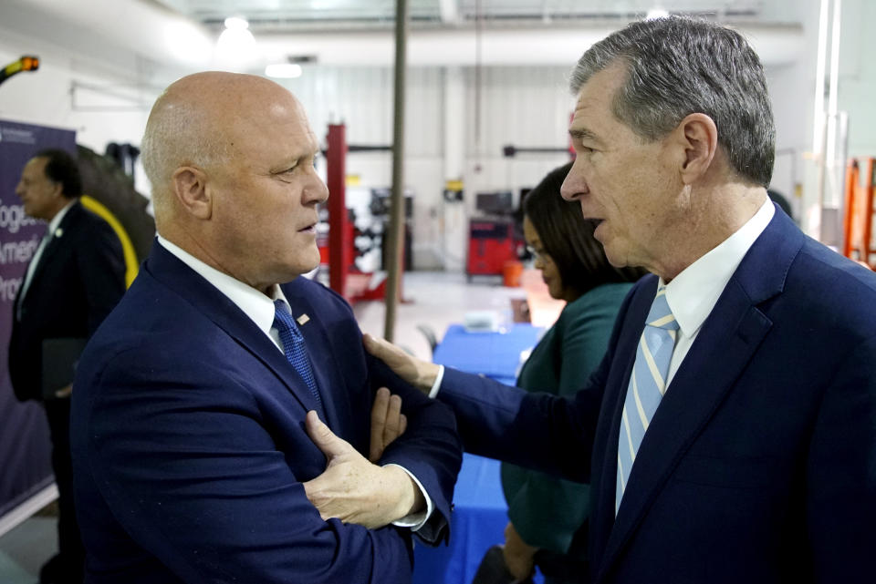 White House senior adviser Mitch Landrieu, left, speaks with North Carolina Gov. Roy Cooper during an event to announce rural broadband funding at Wake Tech Community College in Raleigh, N.C., on Thursday, Oct. 27, 2022. The state was among those divvying up $759 million in grants to expand high-speed internet. (AP Photo/Allen G. Breed)