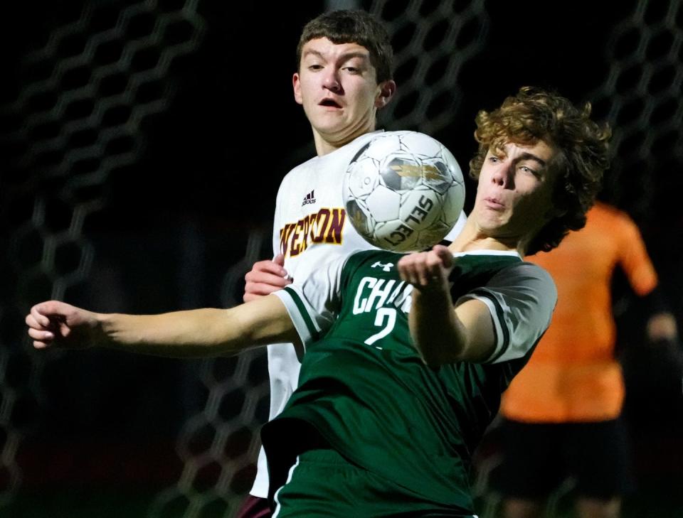 Tiverton Tiger Justin Aucoin and Chariho Charger Brayden Bennett vie for a bouncing ball during first half playoff action on Oct 31, 2023.