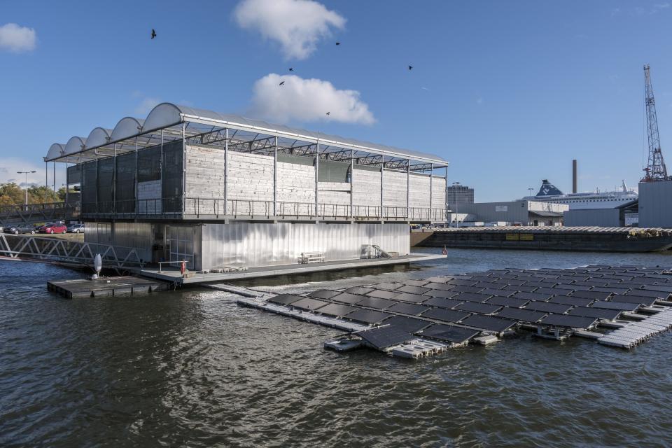 Solar panels sit outside the Floating Farm on Nov. 7 2023, in Rotterdam, Netherlands. The farm’s owners say the extreme weather spurred by climate change — heavy rainfall and flooding of cities and farmland — makes the farm's approach climate-adaptive to feed those cities. (AP Photo/Patrick Post)