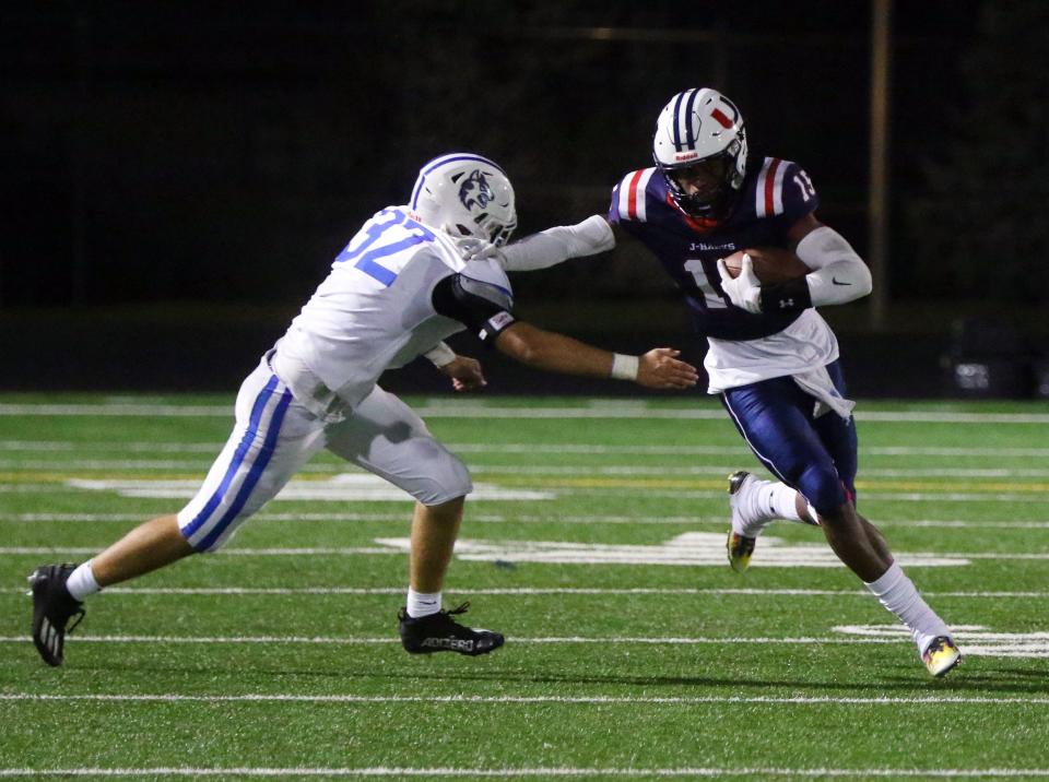 Kai Black of Urbandale runs the ball as the Wolves take on the J-Hawks in Urbandale, Friday, Oct. 22, 2021.