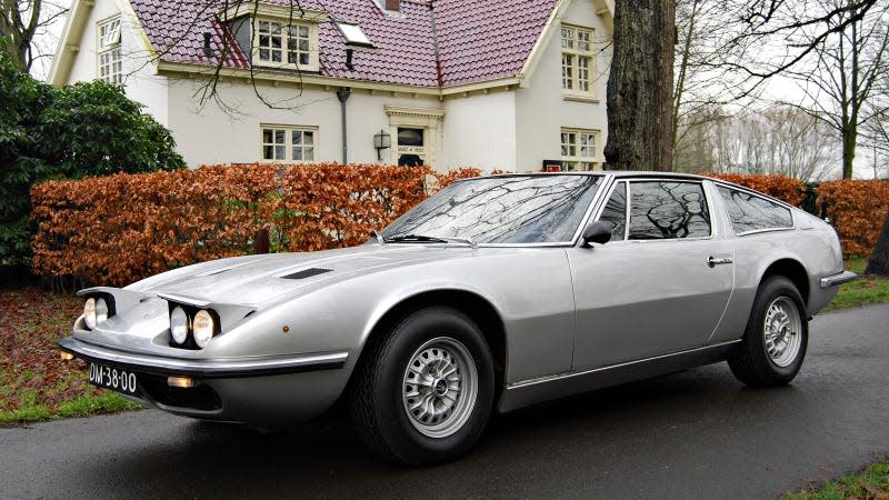 A photo of a silver Maserati Indy sports car. 