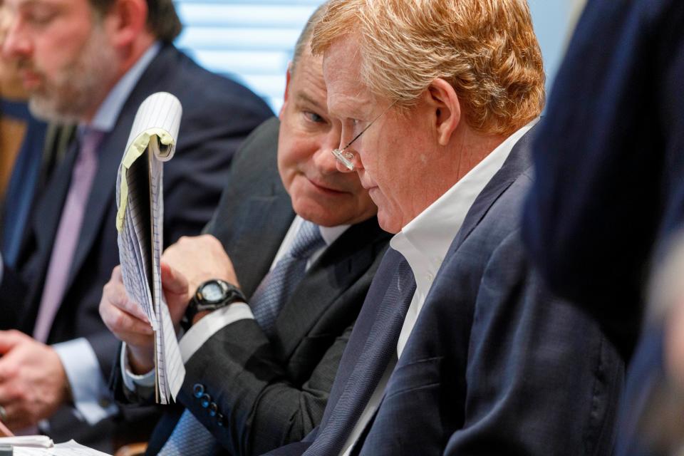 Defence attorney Jim Griffin, left, talks with Alex Murdaugh (AP)