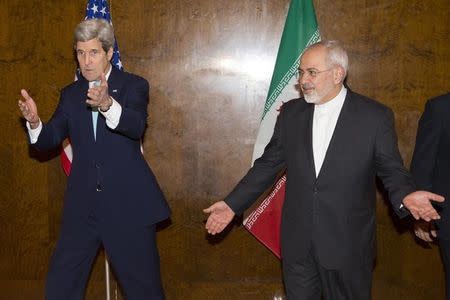 U.S. Secretary of State John Kerry (L) and his Iranian counterpart Mohammad Javad Zarif discuss seating arrangements for a meeting during a new round of nuclear negotiations in Montreux March 2, 2015. REUTERS/Evan Vucci/Pool